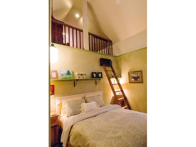 Master bedroom has ladder up to the loft