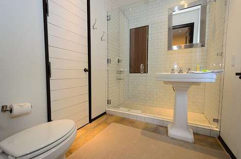 Private bath off queen guest room with large glass enclosed shower