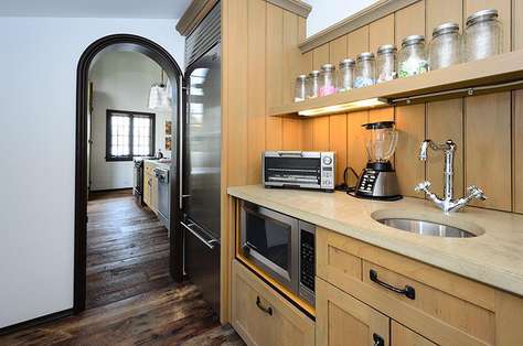 Working pantry located off kitchen to accommodate prep, cleanup, sub zero refrigerator and storage.