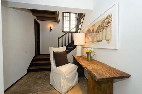 Entryway from loggia/pool area. Charming powder room located halfway up the staircase that serves both the pool and the 2nd floor