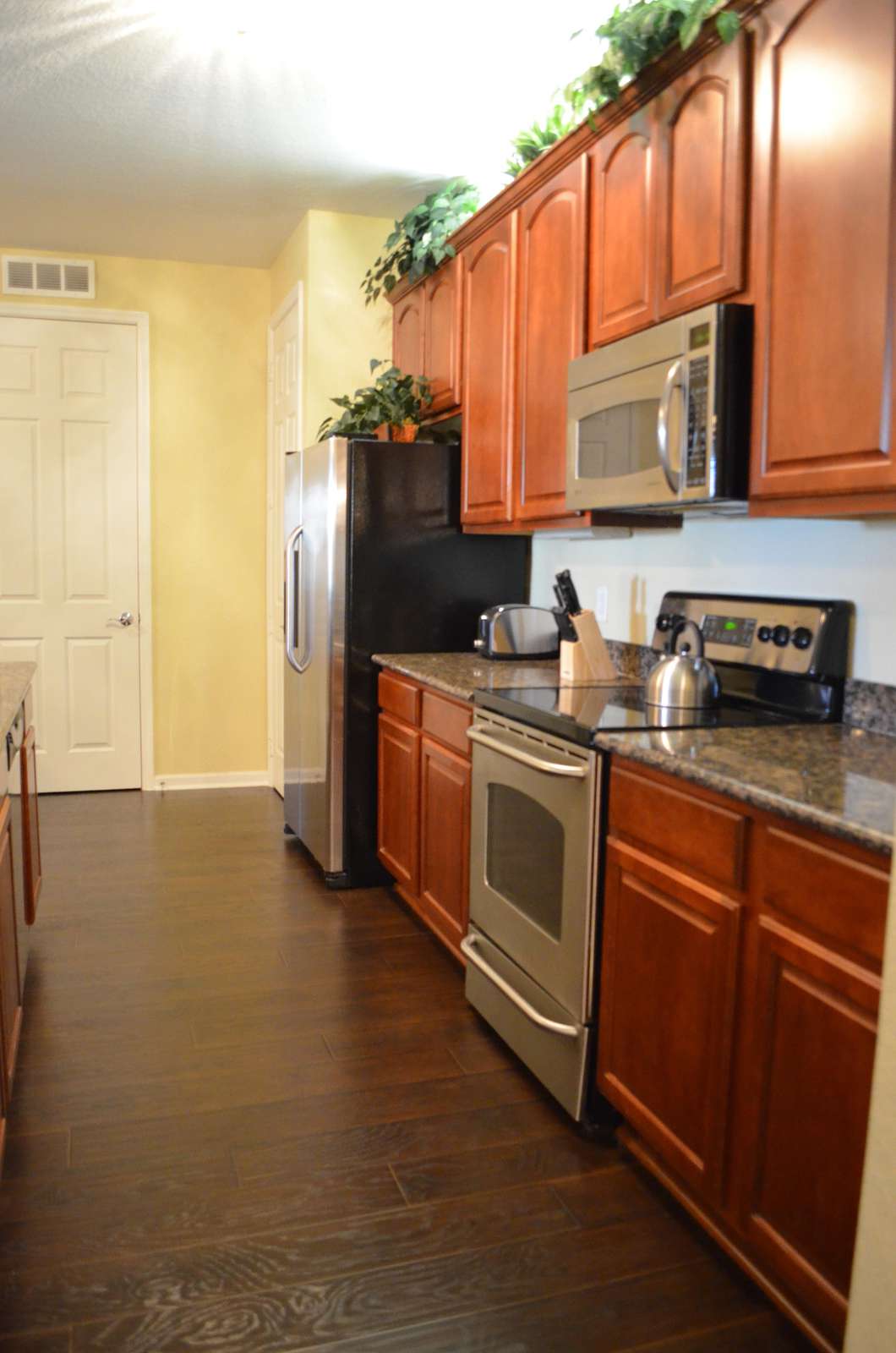 Stainless steel appliances in fully equipped kitchen