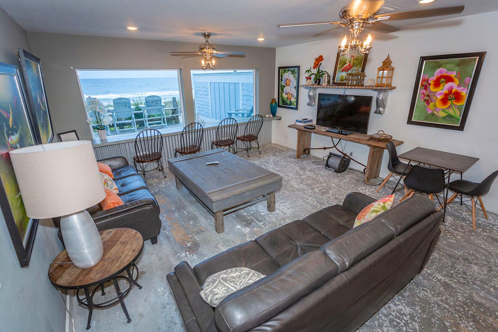 family room with 2 large sofas, flat screen, bar table with 4 chairs, card table with 4 chairs,
