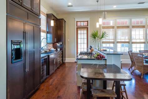 Large kitchen area with refrigerator freezer, wine cooler and bar seating