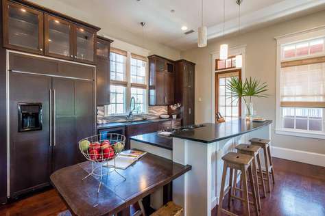 Gourmet Kitchen with Extra Large Refrigerator and Seating Space for 3 at Small Table at End of Island