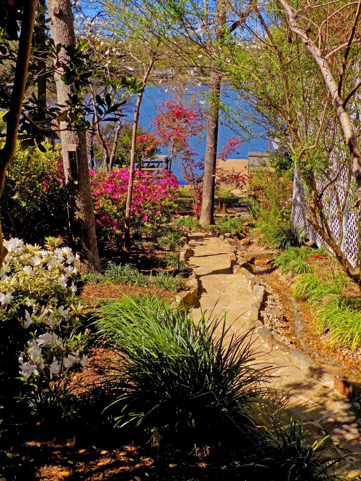 The stone walk down to the lake with a running brook that's pumped from the lake. Sit on the porch and feel the stress melt away.