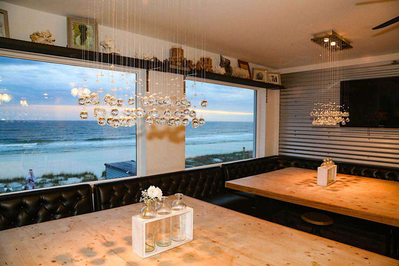 Two large dining tables overlooking the gulf