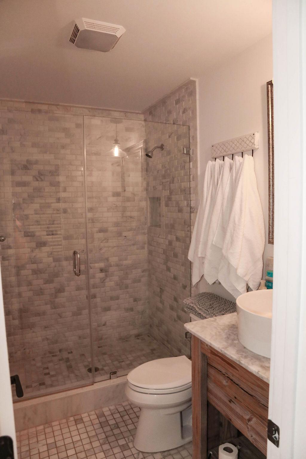 Br # 1 bathroom, white marble shower, glass doors