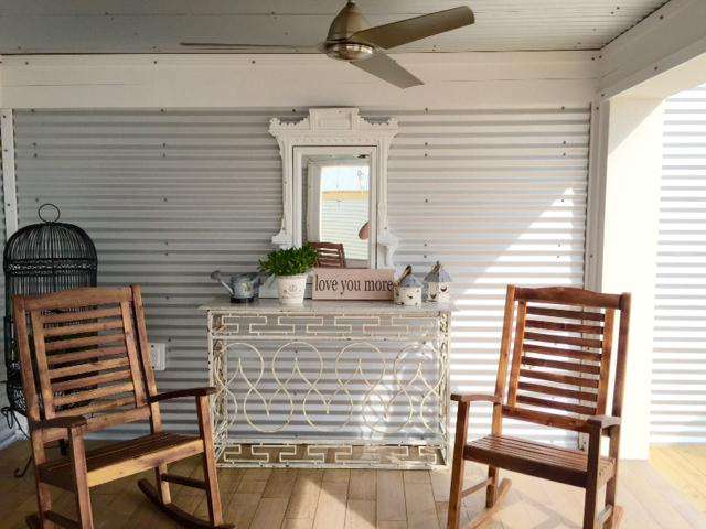 logia with 4 rockers, fans ,sink, overlooking gulf, chairs, tables, umbrella, outdoor showers