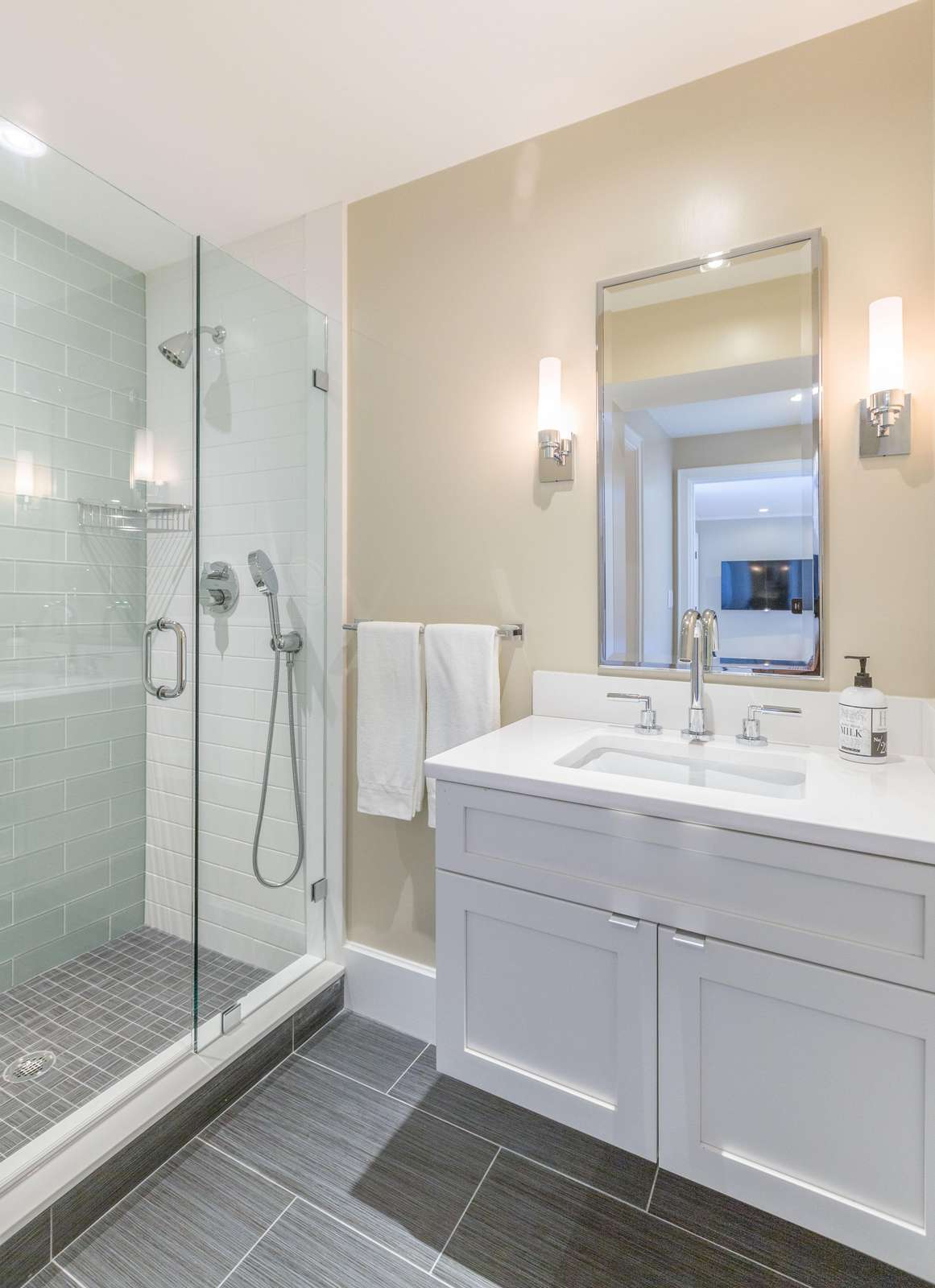 Full bathroom with gorgeous tile shower, glass doors and 2 shower heads