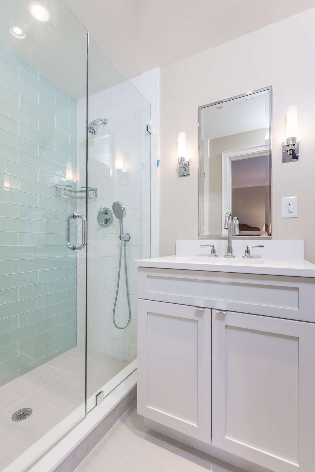 2nd bathroom with tile shower, glass doors and 2 shower heads