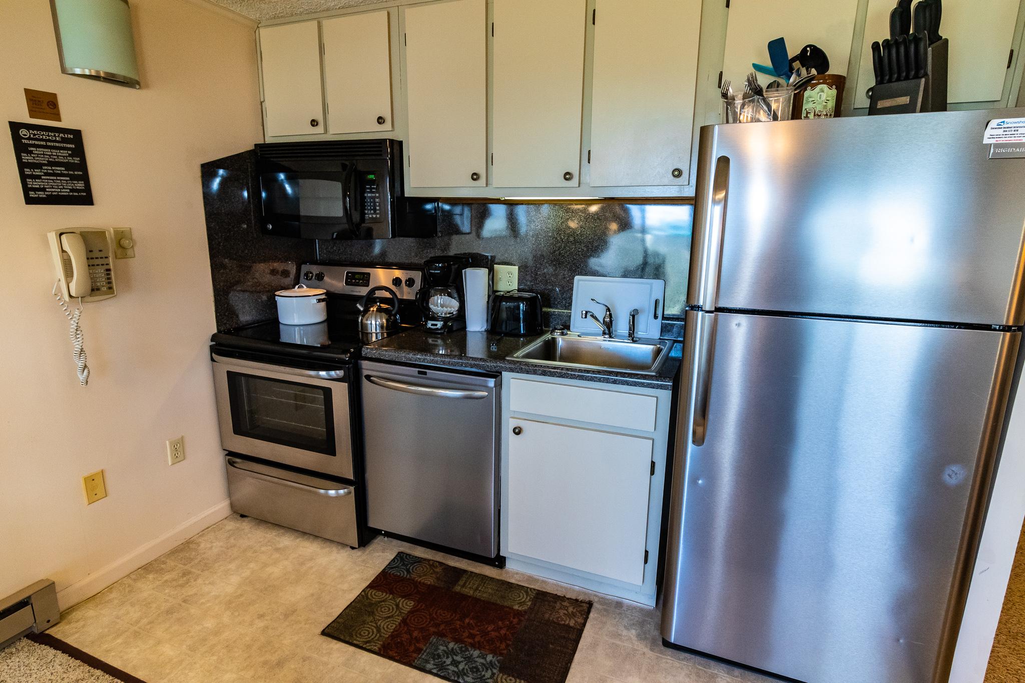 Fully-equipped kitchen with stainless steel appliance, pots, pans, utensils!