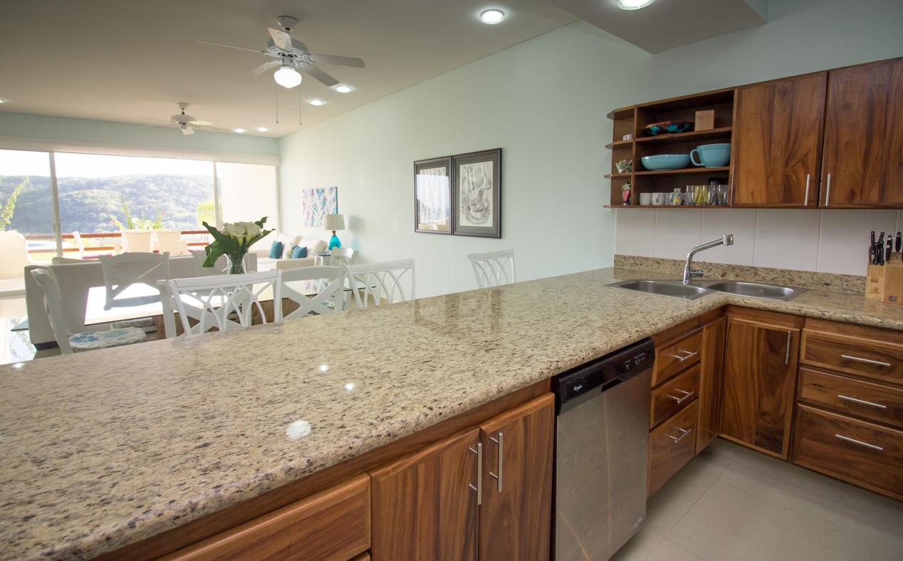 Granite countertops and stainless steel appliances in the fully equipped kitchen