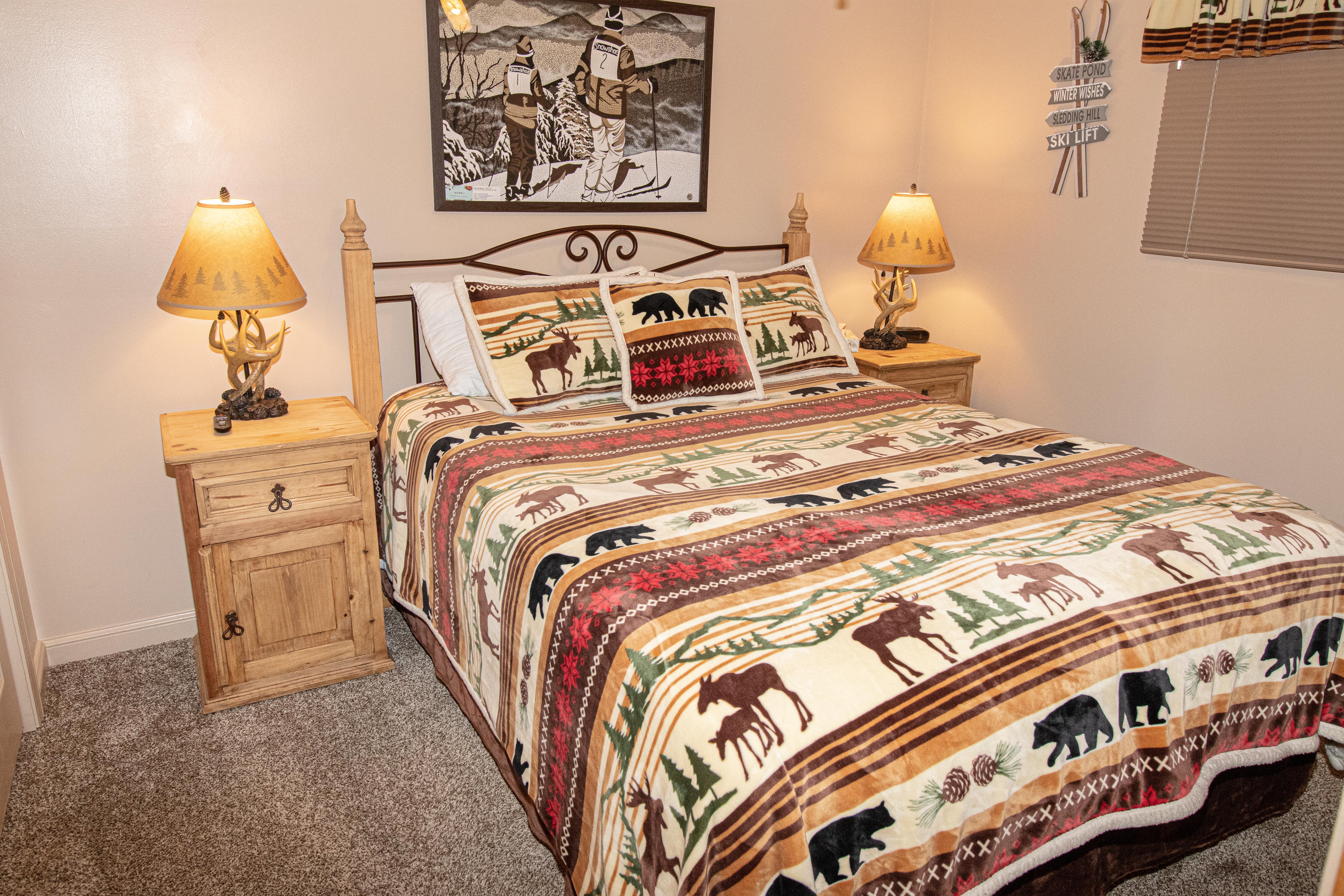 Queen size bed, TV, & ceiling fan in comfy bedroom