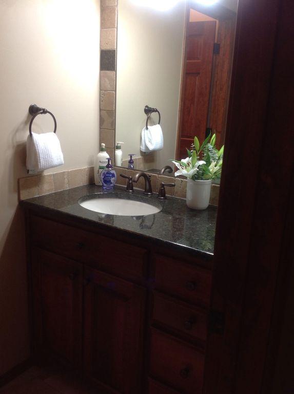 Vanity with big bottle lotion and a hotel size sham.& cond., hair dryer