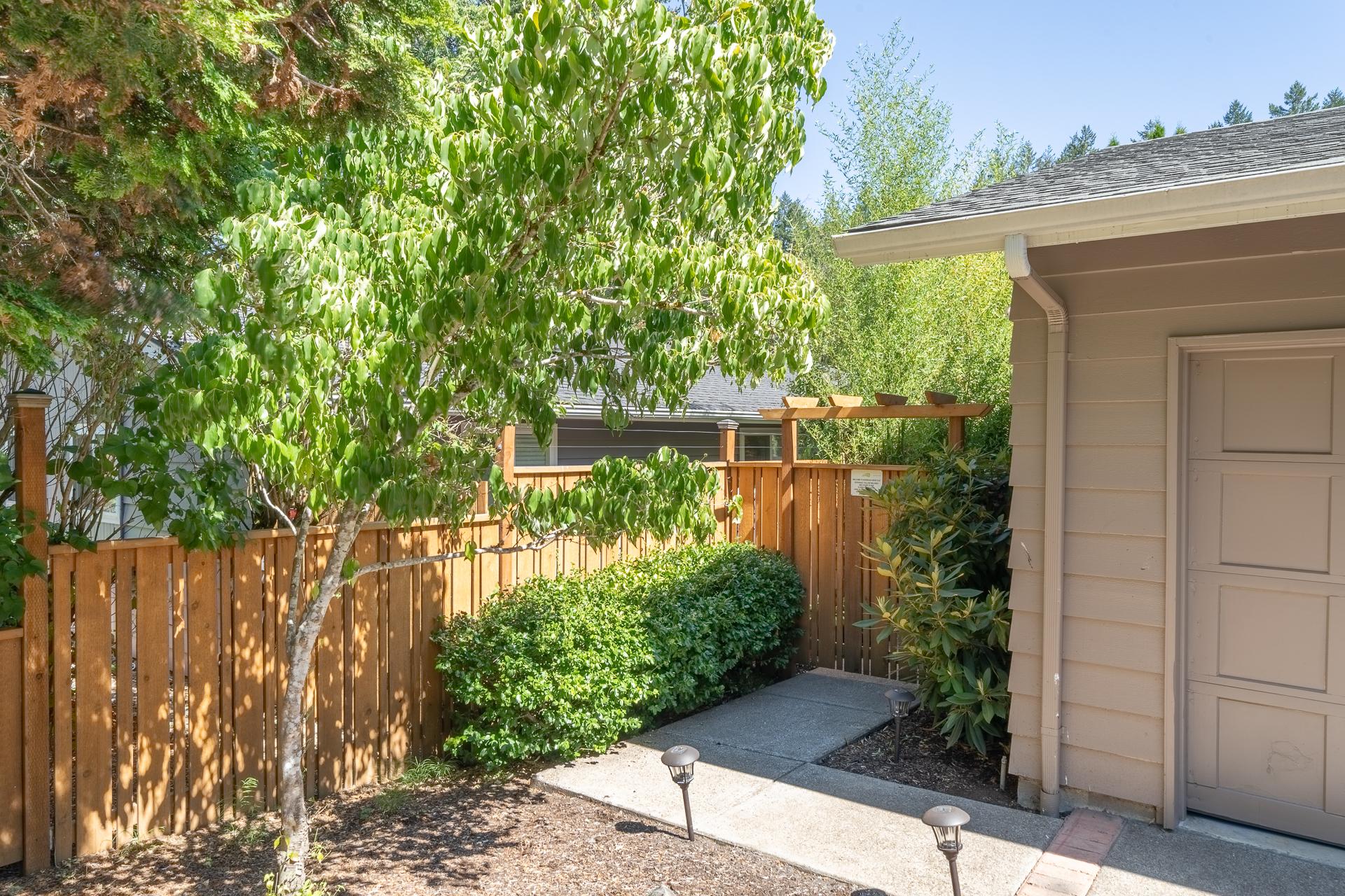 Take the gate to the left of the garage