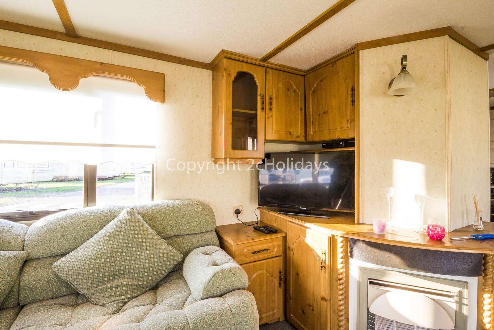 Homely lounge with a TV and a gas fire