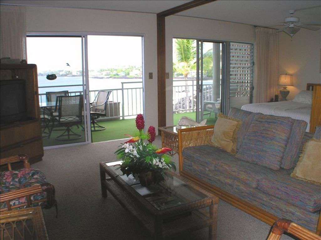 Comfortable living room with adjacent master suite both with sliders to lanai.