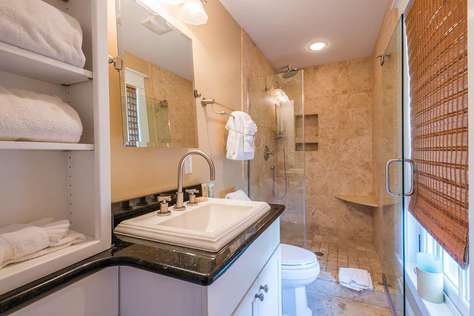 Master bathroom with glass enclosed shower.