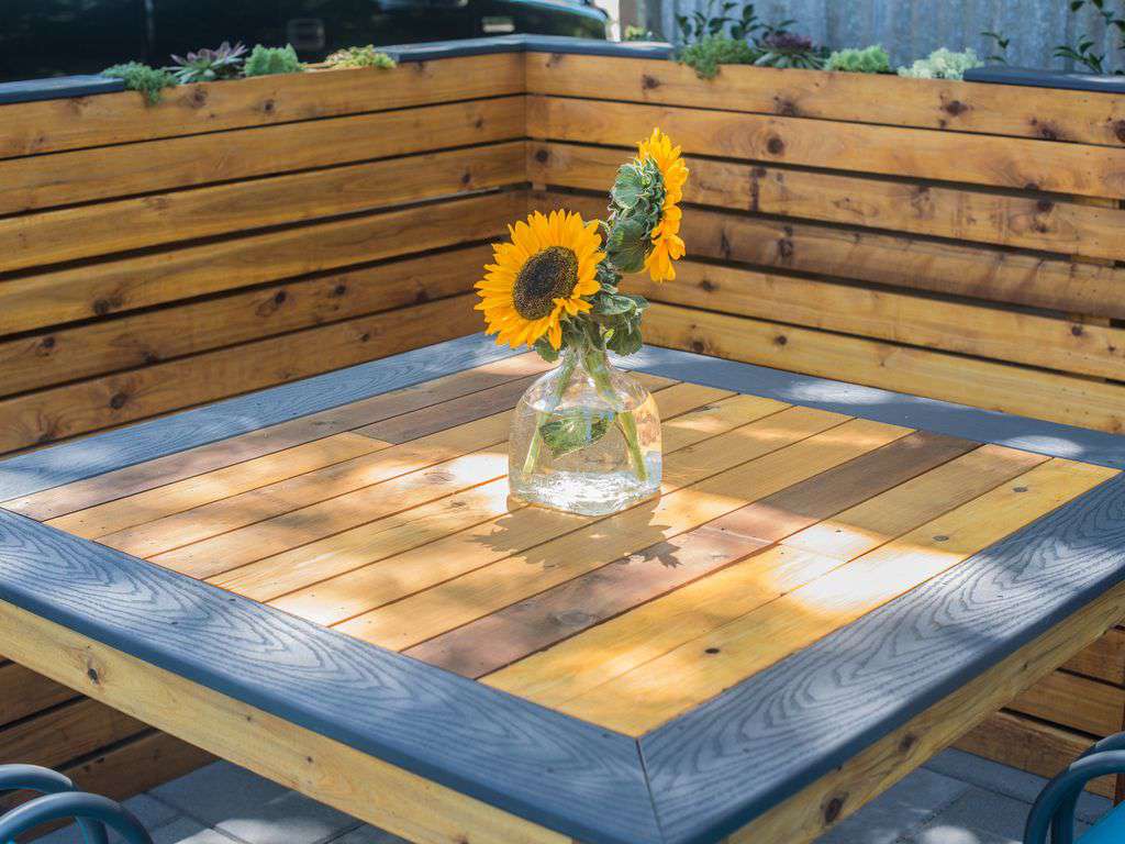 An outdoor picnic table is super fun to hang out and eat meals or share a drink.