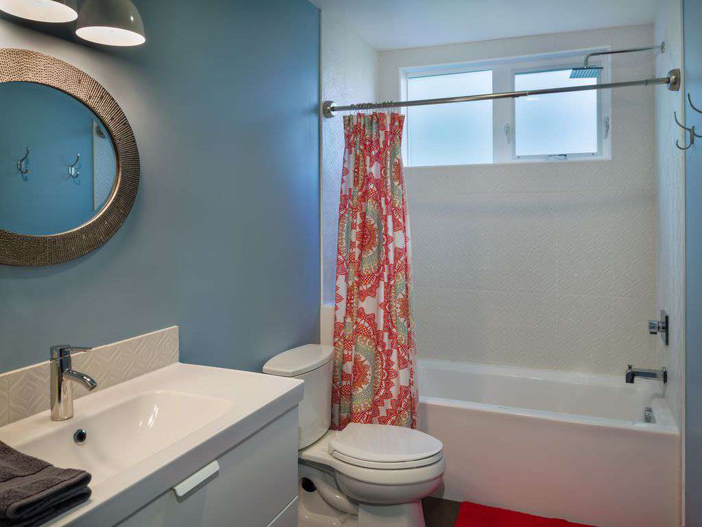 1 of 3 full bathrooms, with tub for kids, and rain head shower too!