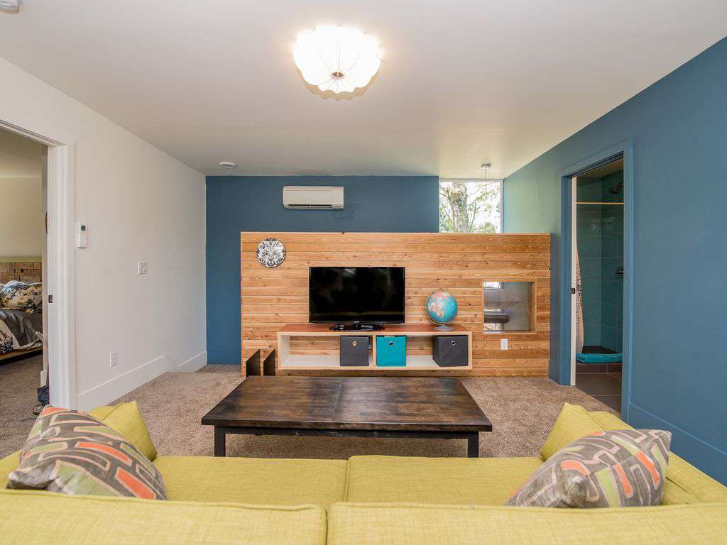 Den area with second TV, games, and toys.