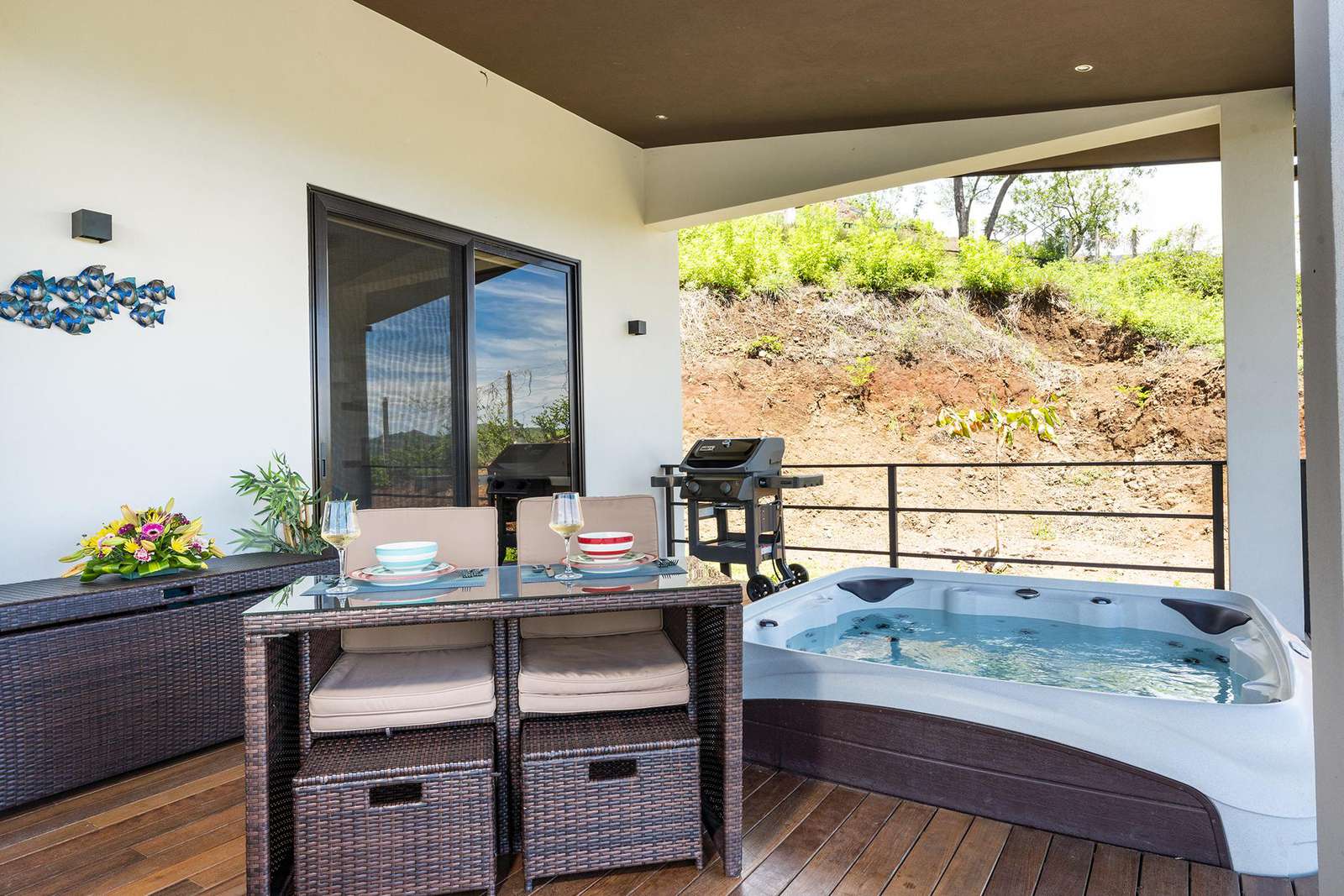 Oversized covered terrace with Jacuzzi, outdoor dining area and loungers