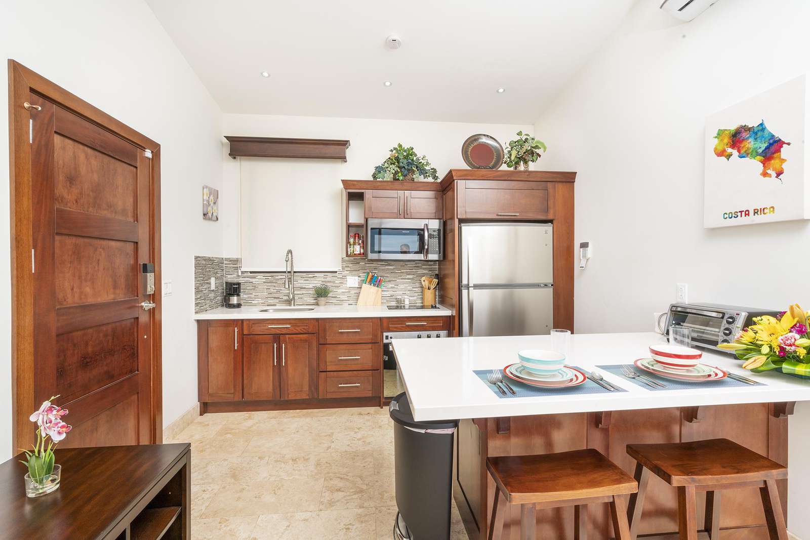 View of gourmet kitchen, breakfast bar, main entry