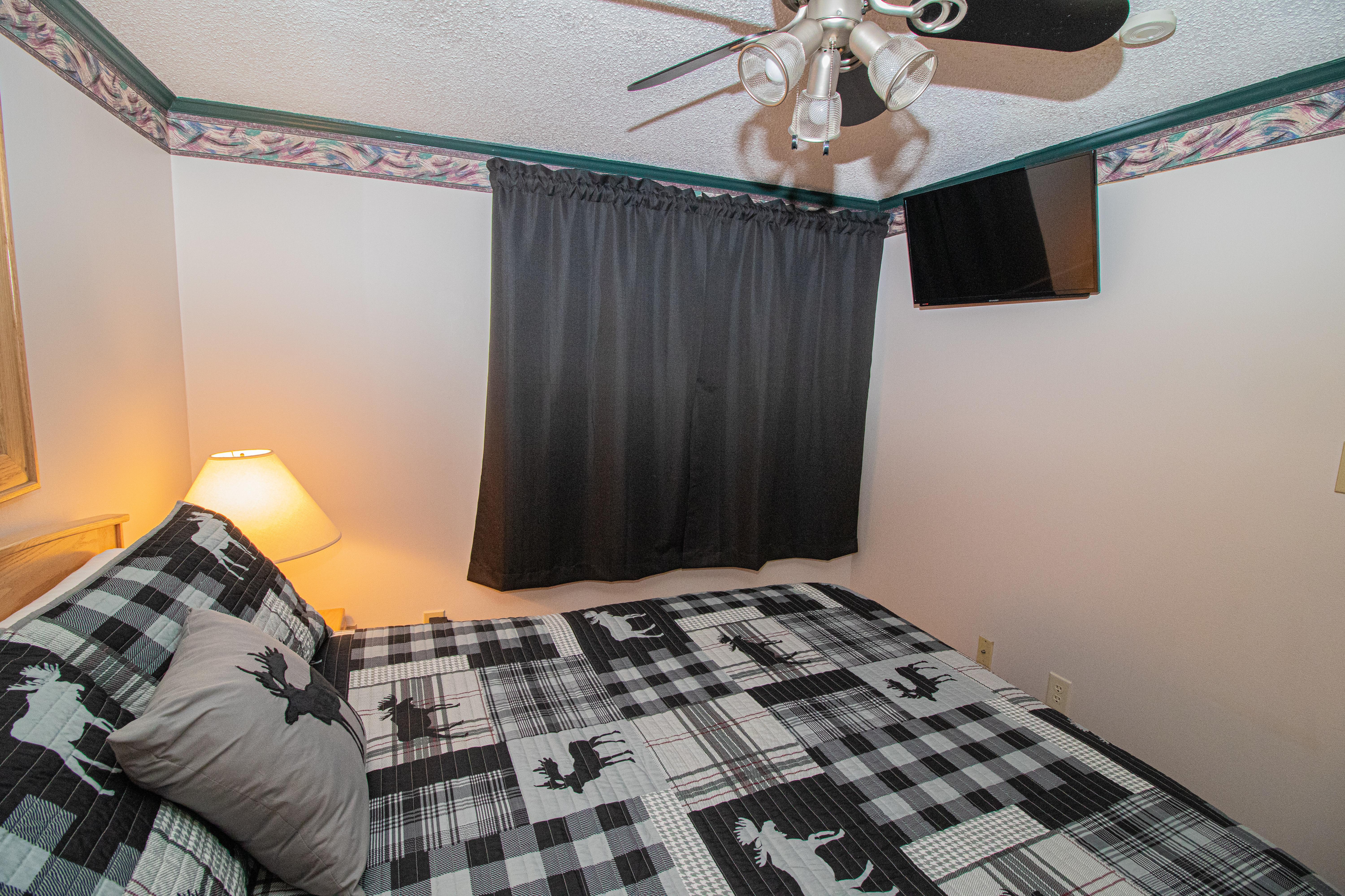 Queen-sized bed in bedroom; Flat Screen TV