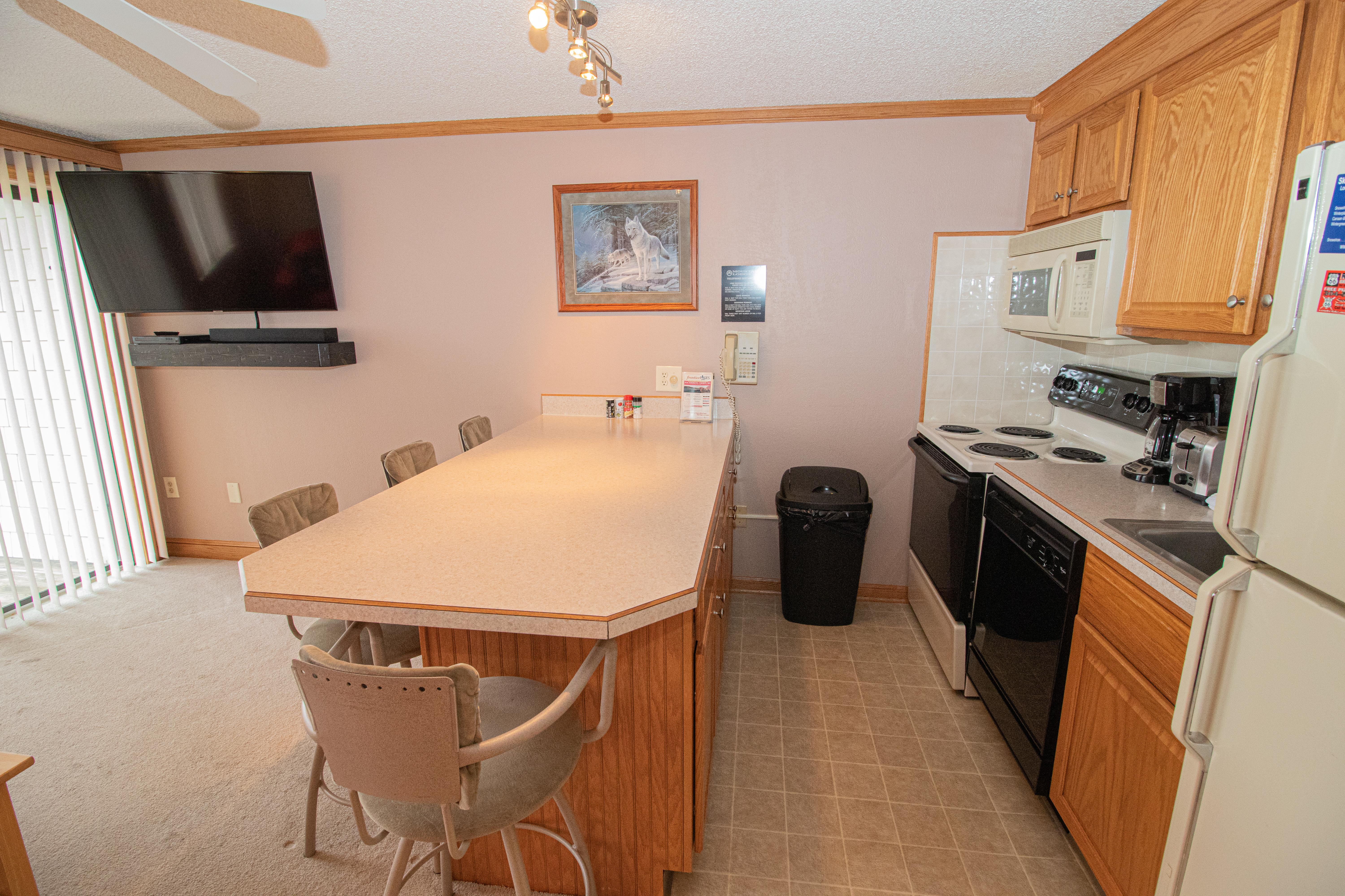 Remodeled kitchen is fully-equipped with pots, pans & utensils