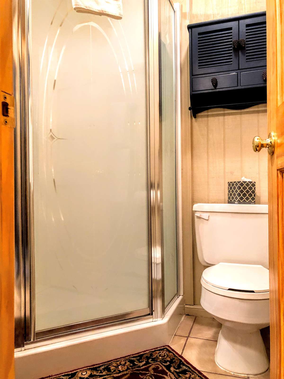 Full second bathroom in hallway next to second bedroom; has a shower enclosure.