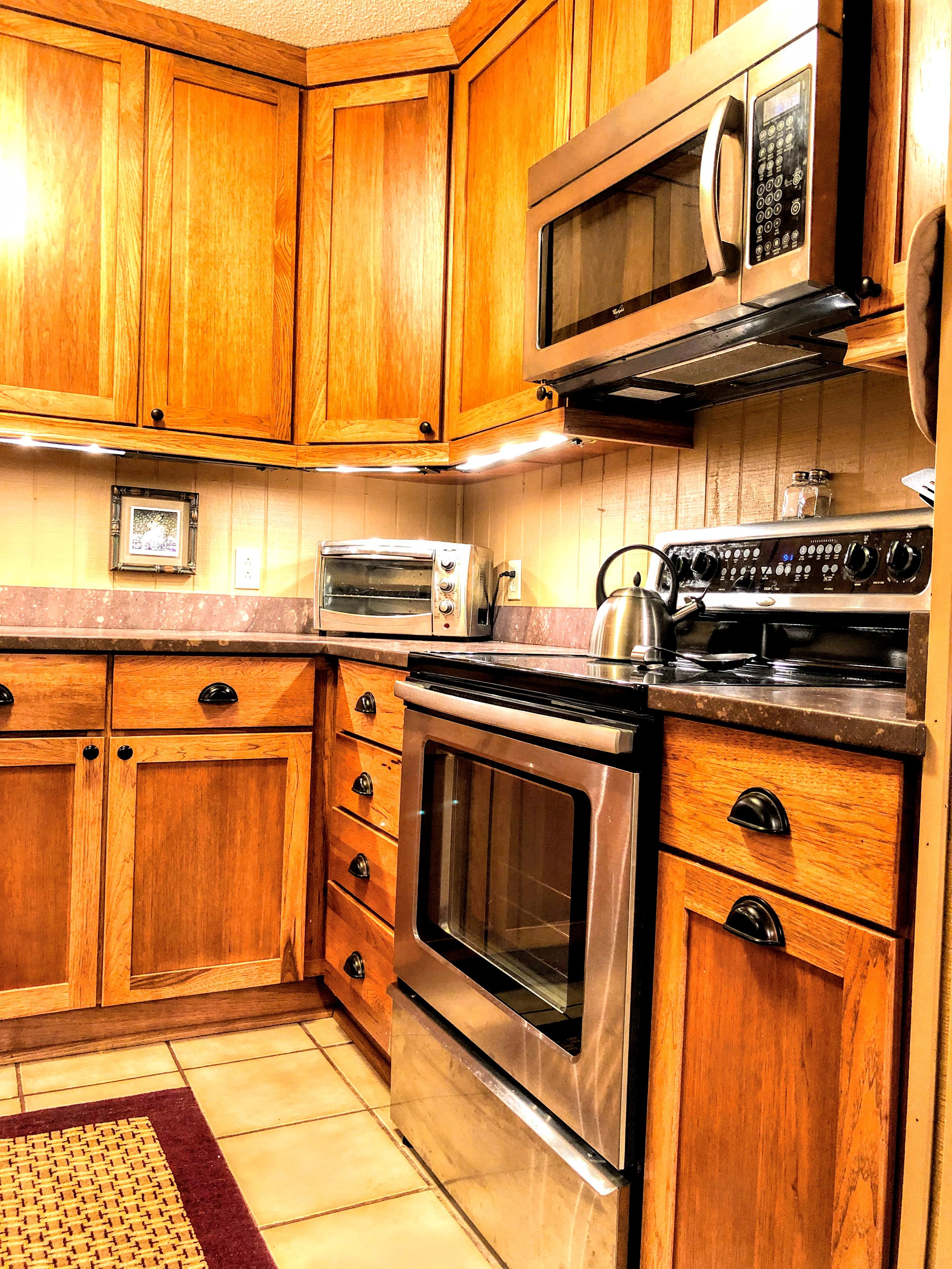 Fully-equipped kitchen (pots, pans, utensils, spices, cookware, etc.) with oak cabinets, solid-surface counter-tops, and stainless steel appliances!