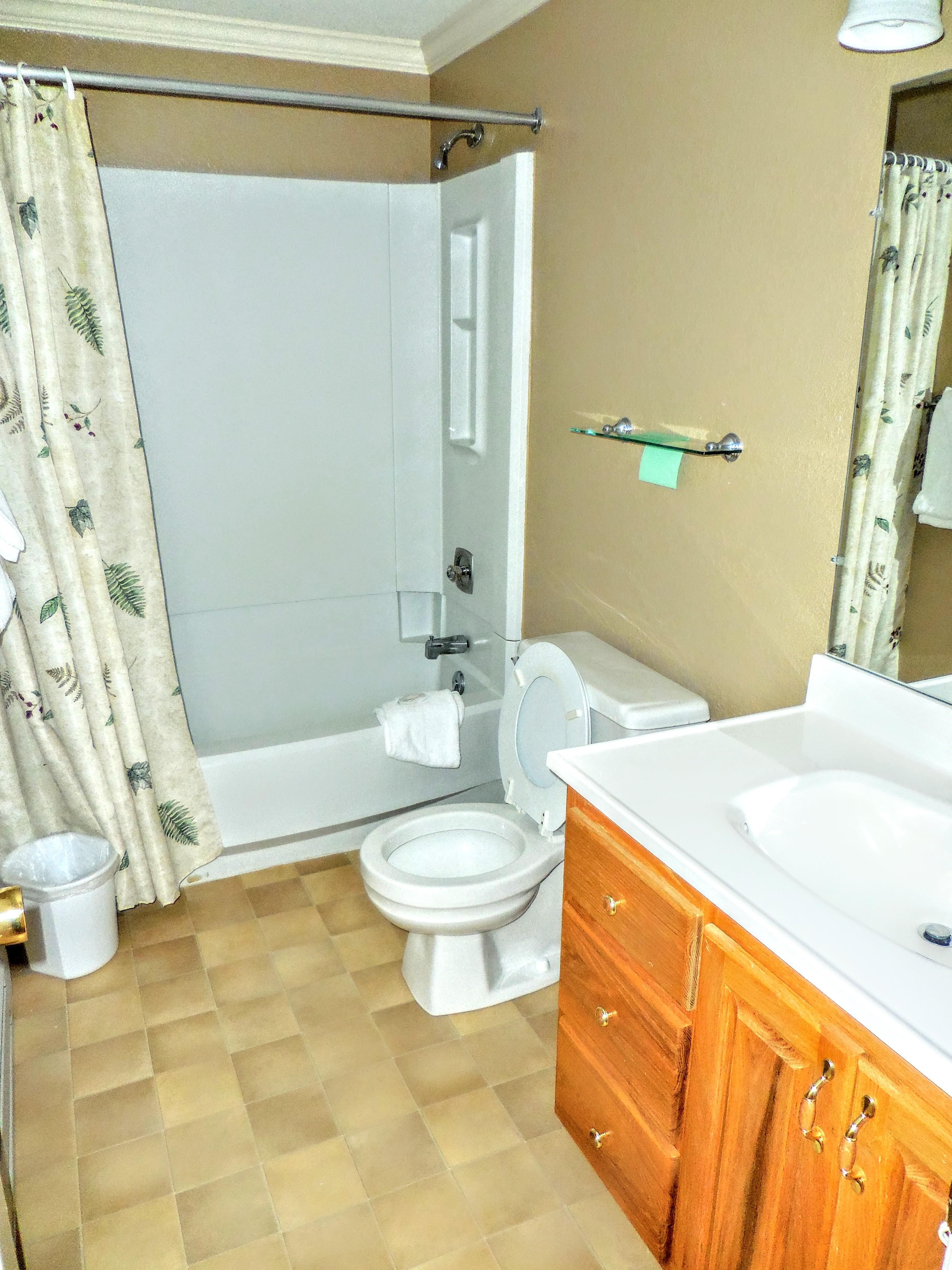 Full-sized second bathroom in hallway includes tub and shower.