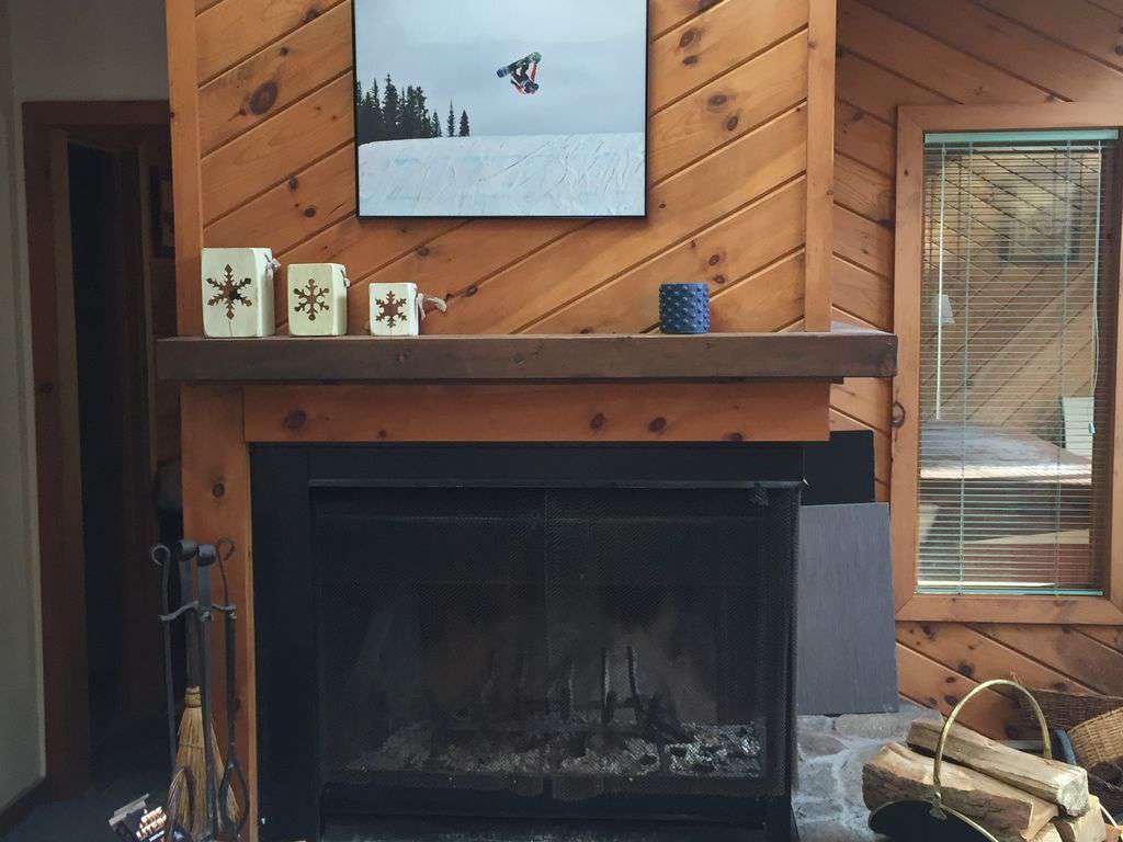 Family room fireplace, wood supplied to your front door, and hot tub room visible in room behind fireplace.