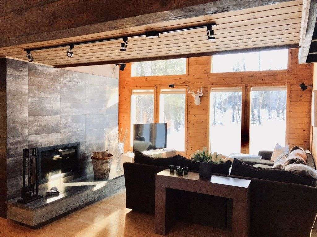 Step into sunlight, wood beams, and an inviting family room with dramatic fireplace.