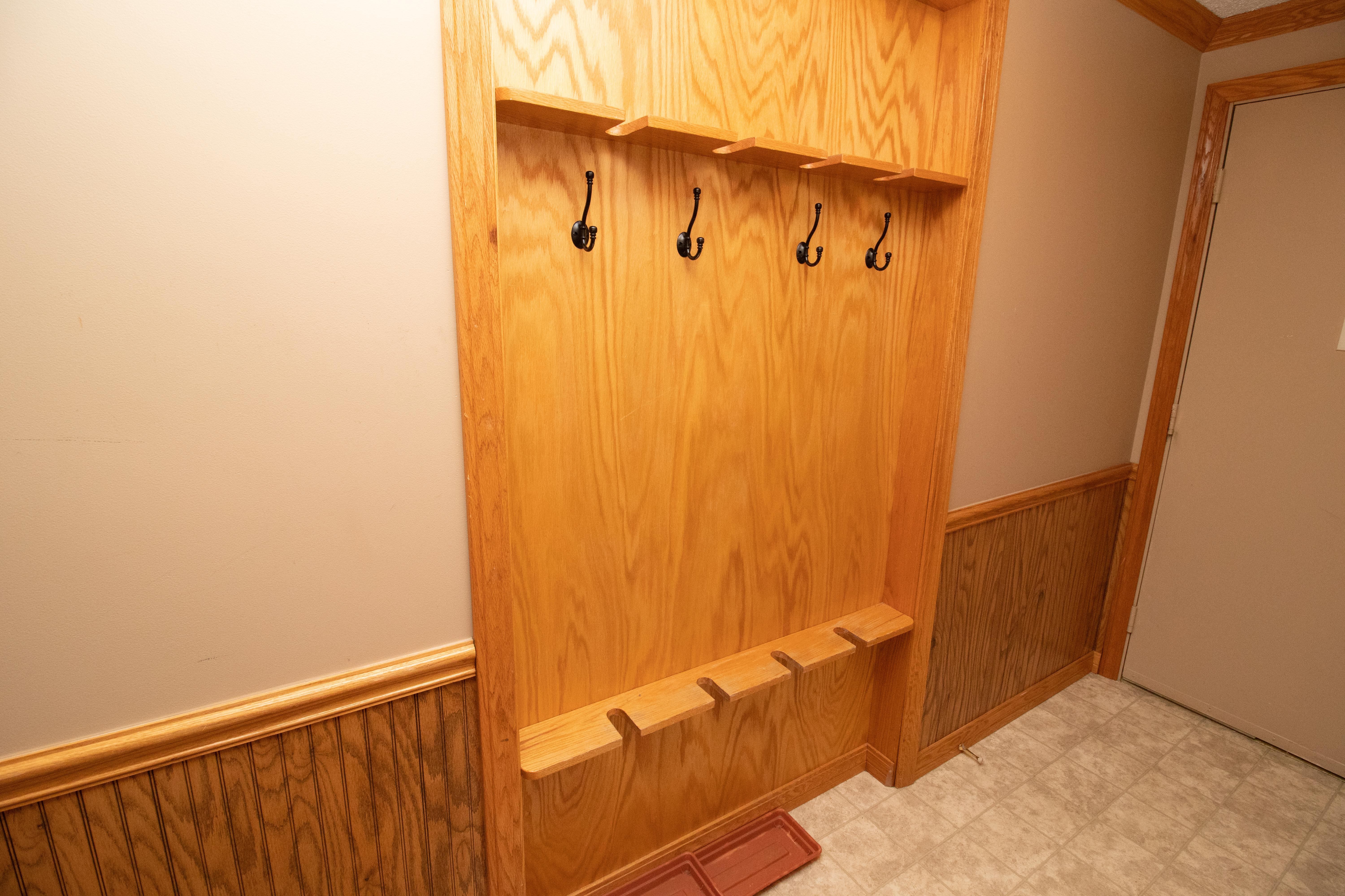 Safely store your gear inside the unit; recessed oak ski rack in hallway