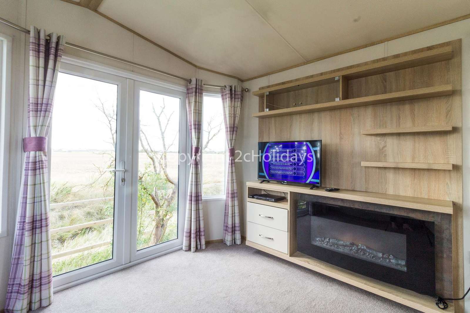 Light and airy lounge area with a TV and electric fire!
