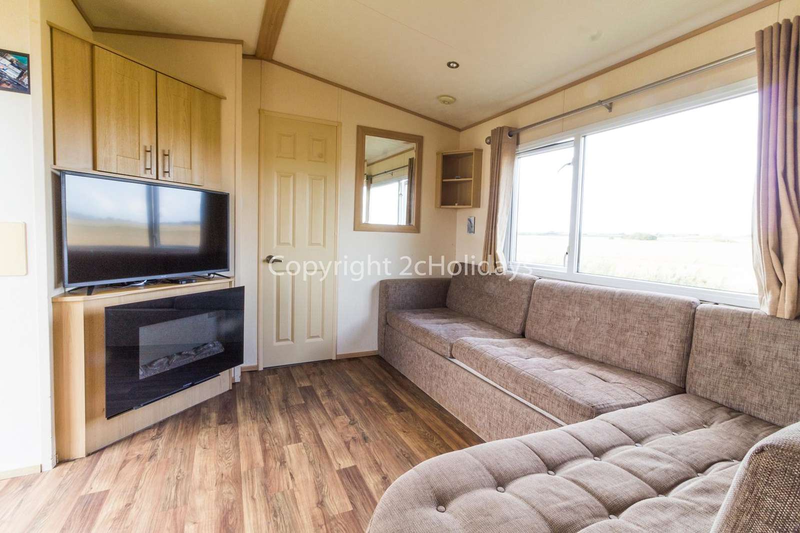 Spacious and modern lounge with a TV and an electric fire