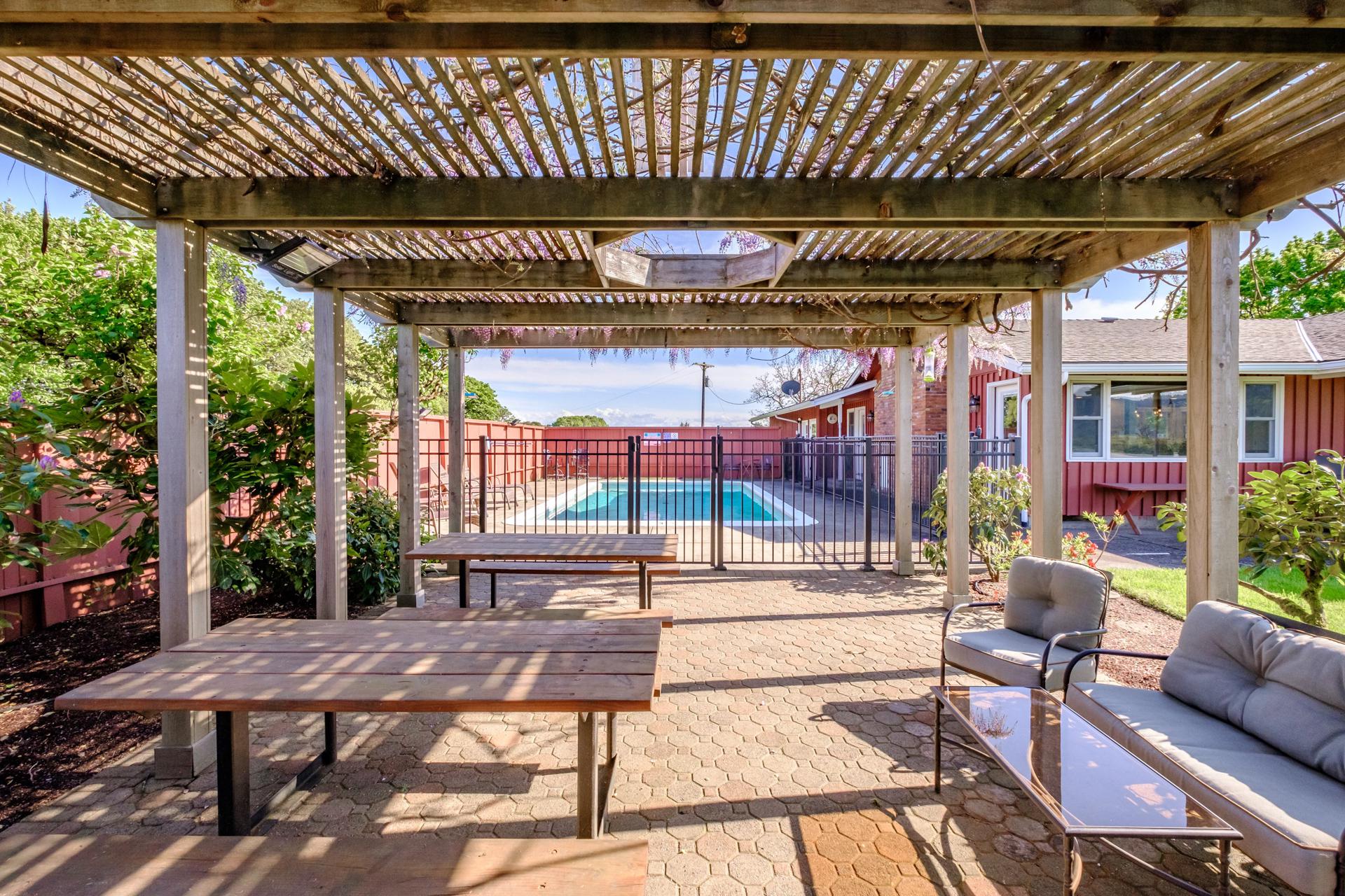 Pergola with seating arranged for family dinner!