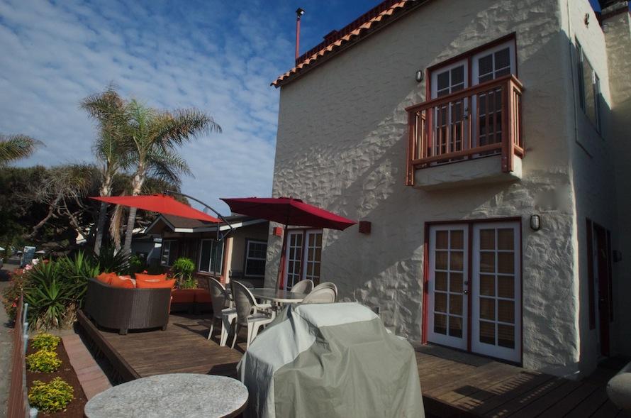 Front of House with Barbecue, Table and Chairs and Patio Furniture