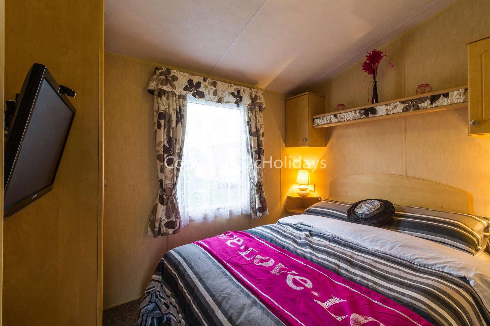 You can find plenty of storage in this master bedroom with a TV!