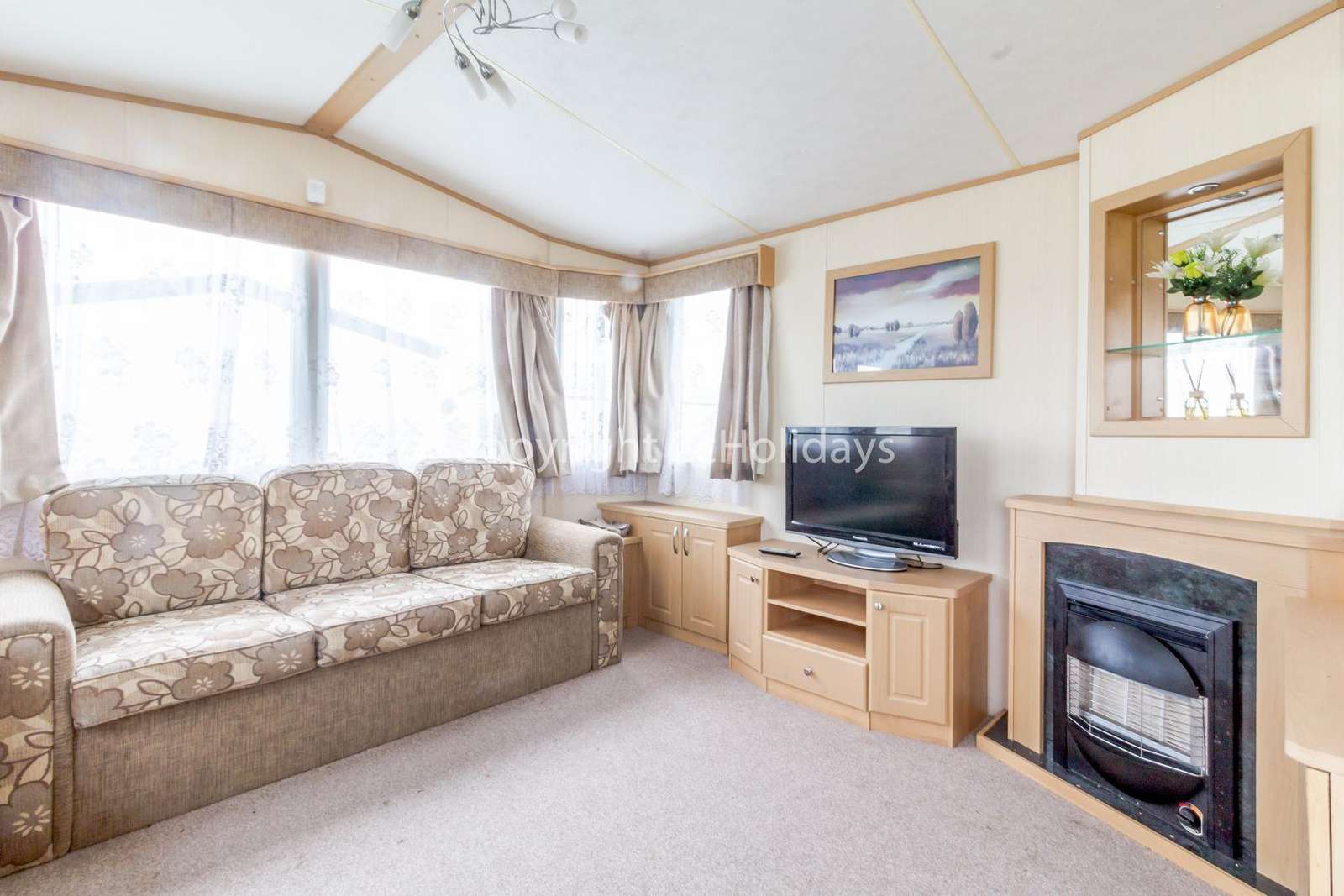 Cosy feel with a modern TV and a gas fire