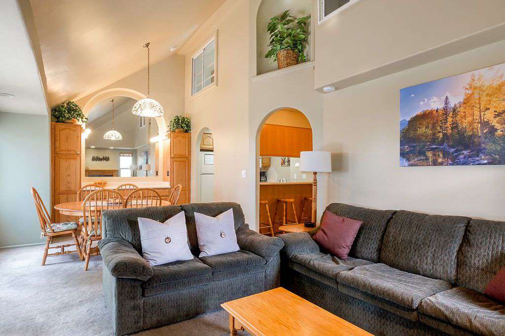 Second floor living room with 2 sofa beds, dining table, and kitchen area