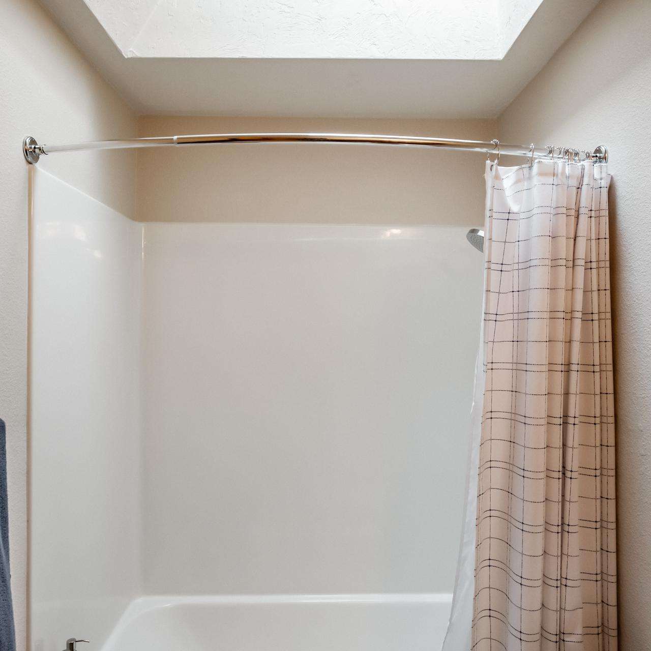 Tub Shower with skylight in the hall bathroom