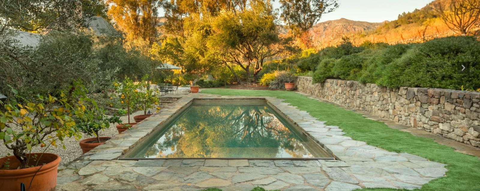 Heated pool w/ cover to left of and behind Villa 1