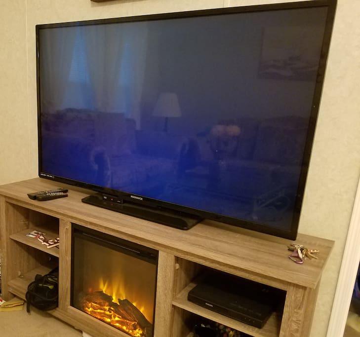 Large Flat Screen TV w/WOW Cable, DVD Player and electric Fire place