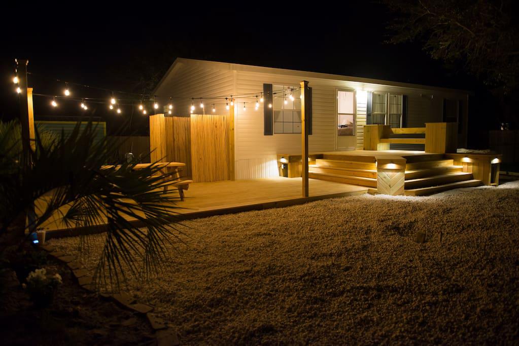 Huge Outdoor Deck with String Lights and accent lights, picnic table, outdoor shower, charcoal grill (charcoal not provided) & palm trees