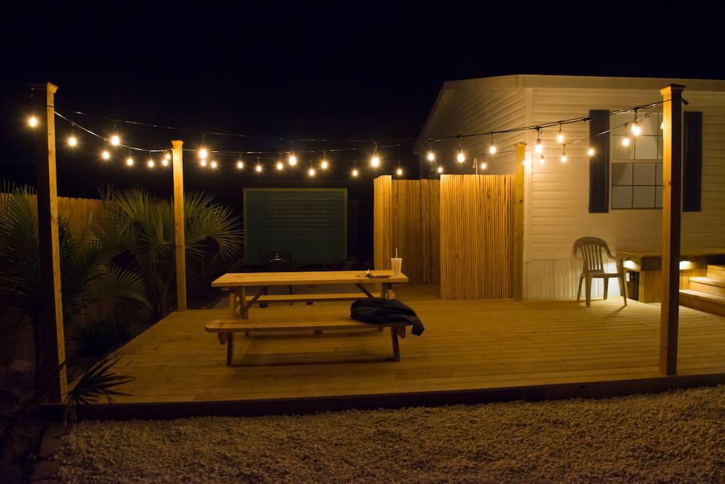 Night view of deck with Accent Lighting and String Lighting