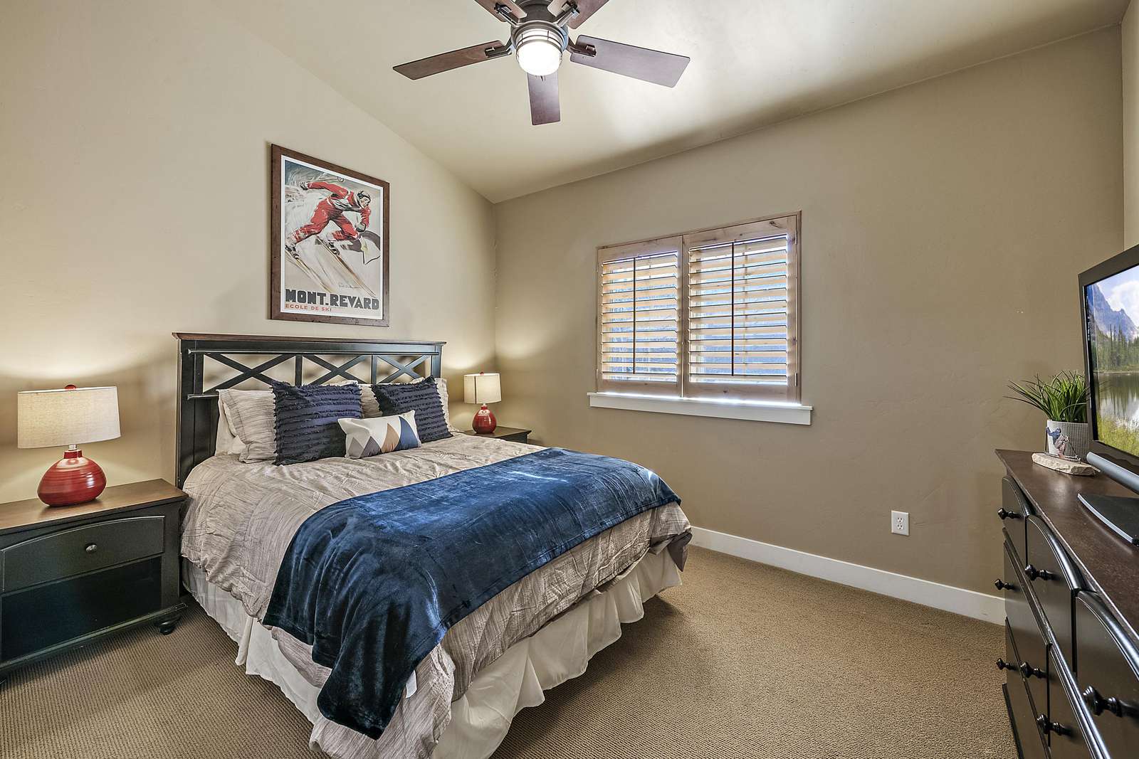 Guest bedroom contains dresser and TV