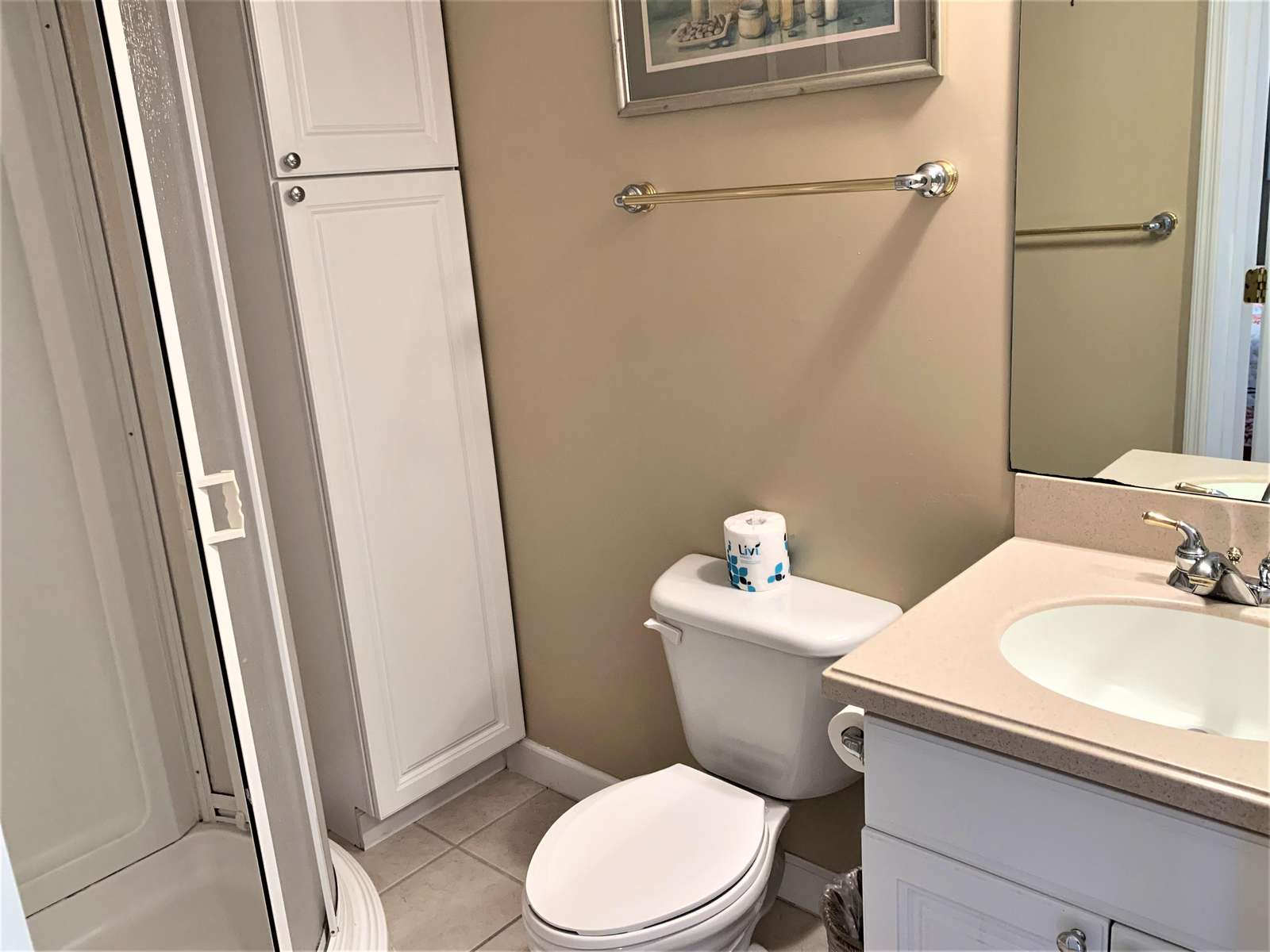 Bath with shower, vanity, and storage