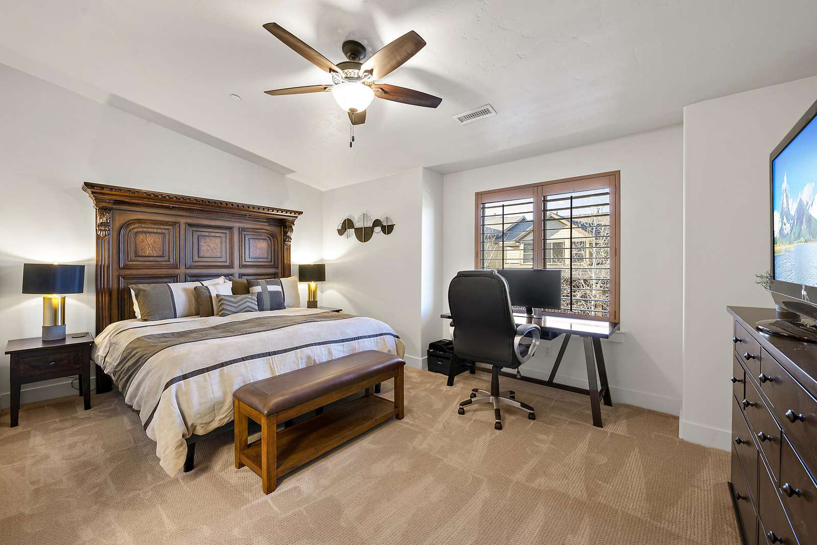 Master bedroom with work space and TV